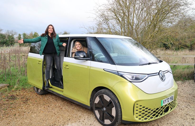 Ginny Buckley and Nicki Shields with a white and yellow Volkswagen ID.Buzz